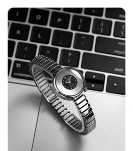 Close-up of GEDI silver quartz watch with elastic band placed on a laptop keyboard