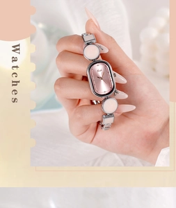 Detail view of oval rose gold dial and pink resin bracelet chain for women quartz watch