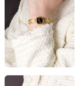 Macro shot of GEDI vintage gold chain watch worn on wrist with tweed jacket background
