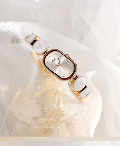 Close-up of elegant Gedi oval watch featuring rose gold metal and enamel link bracelet