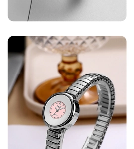Close-up of GEDI women's watch with pink dial, crystal indices and elastic silver band
