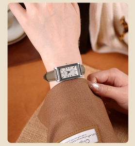 Close-up of GEDI rectangular quartz watch with grey dial and khaki leather strap on wrist