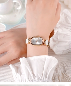 Close-up of Gedi oval quartz watch with rose gold links and white ceramic accents