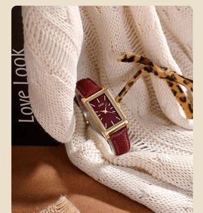 Close-up of vintage square wine red quartz watch with gold case on a knit sweater background