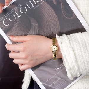 Elegant gold elastic band watch for women featuring a white dial and premium metal finish