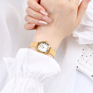 Elegant GEDI women square watch with gold mesh band on wrist with stylish background