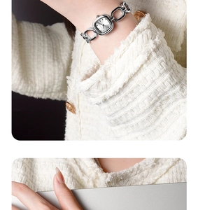 Silver square dial bracelet watch on wrist paired with an elegant tweed jacket