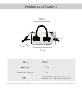 Detailed dimensions of white velvet bucket bag with black bows and adjustable strap