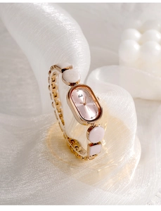Macro shot of an elegant oval quartz watch with a unique rose gold chain bracelet design
