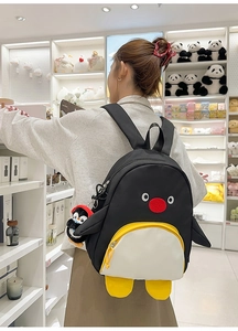 Détail du sac à dos pingouin mignon avec breloque en peluche et détails en 3D