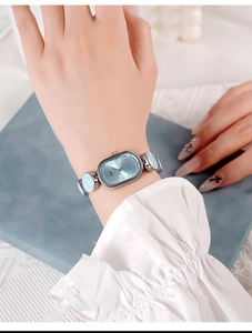 Close-up of elegant oval blue dial quartz watch with vintage silver metal bracelet