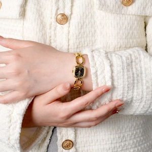 Elegant gold chain bracelet watch for women featuring a minimalist black square dial