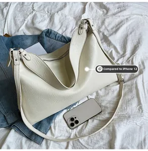 Macro shot showing the spacious interior of the tote bag compared to an iPhone