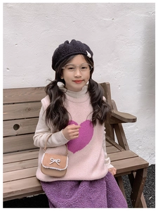 Détail d'un mini sac à main en cuir marron avec un joli nœud blanc de décoration