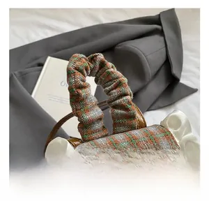 Detailed macro view of children's checkered backpack with lace trim and plush puppy accessory