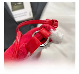 Detail of red plush handbag showing soft sheepskin trim and durable silver metal hardware