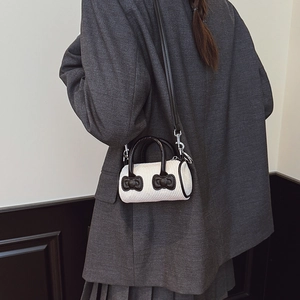 White corduroy mini bucket bag with cartoon character relief and black leather straps
