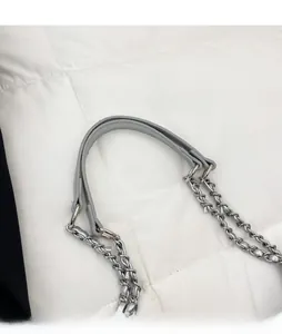 Detail of grey pebbled leather shoulder strap with durable silver metal chain link