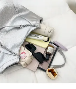 Spacious silver tote bag showing capacity with sunglasses and daily essentials