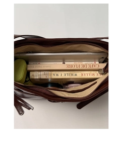 Top view of spacious interior of brown PU leather tote bag with tablet and daily essentials