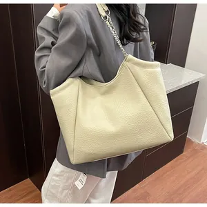 Detail of premium lychee grain faux leather texture on large cream-white tote bag