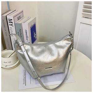 Detail of silver metallic hobo bag with pleated texture and stylish silver chain accent