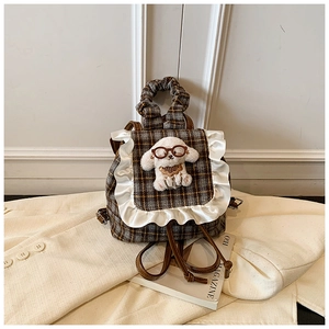 Detailed view of kids vintage plaid backpack with lace trim and plush puppy doll