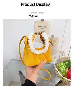 Detail of yellow fuzzy mini handbag with soft white plush handle and thin crossbody strap