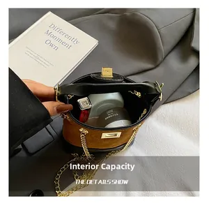 Detail view showing internal capacity of the brown suede bucket bag with cosmetics