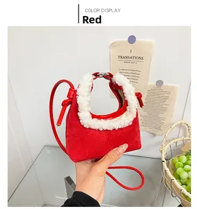 Detail of red suede dumpling bag with white faux fur trim and knot leather strap