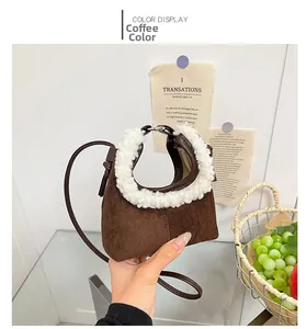 Detail of coffee brown plush crescent bag with white faux shearling trim and strap