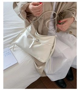 Detail of minimalist beige PU leather tote bag with stylish buckle and smooth finish