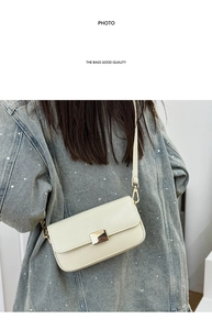 Close-up of cream square shoulder bag with gold metal lock on a denim model