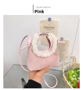 Detail of pink faux suede mini handbag with white faux shearling handles for autumn winter