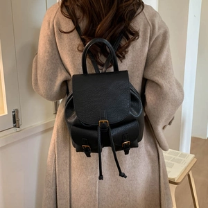 Fashionable black faux leather backpack for women featuring drawstring and buckle closure
