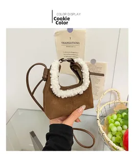 Brown suede mini handbag with fluffy white fleece handle detail shown in lifestyle setting