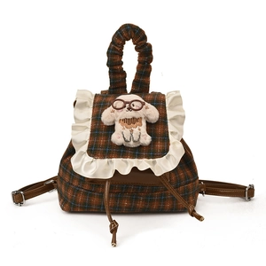 Checkered plaid kids backpack with lace trim and plush puppy mascot on white background
