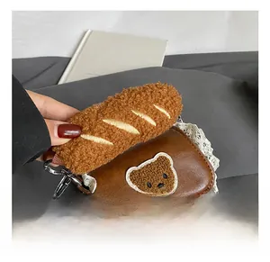 Detailed view of brown PU leather bag with white lace trim and bear embroidery detail