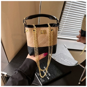 Detail of color-block kids bucket bag with quilted suede and golden chain strap