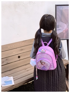 Detail of purple sequin kids backpack with princess print and plush cat keychain