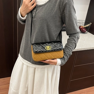 Chic quilted crossbody bag in black and brown contrast leather with golden buckle