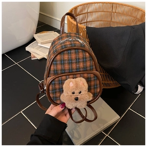 Detail of plaid mini backpack featuring a plush bear and vintage checked fabric