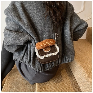 Rear view of model wearing a vintage brown lace crossbody bag with bear embroidery