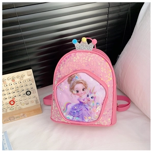 Close-up of pink girls backpack with shiny sequins, crown decor, and unicorn graphics