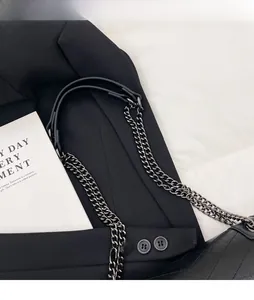Detail of durable black leather shoulder strap with dark gunmetal chain and comfort pad