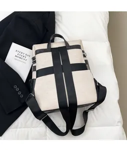 Detail view of large canvas travel backpack with chic color-contrast straps and side zipper