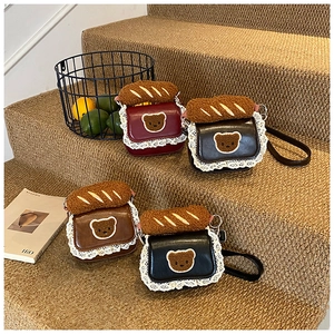 Detailed view of mini lace crossbody bags with teddy bear patches and plush bread decor