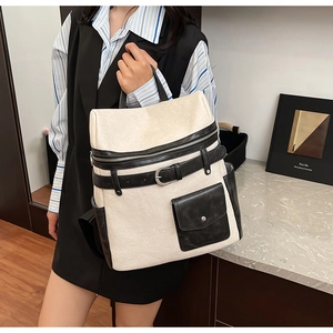 Detail of minimalist contrast color backpack with flap pocket and silver metal buckle