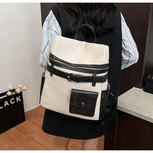 Detail of contrast stitching and textured woven material on modern women backpack