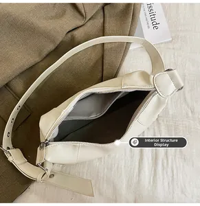 Internal structure of off-white PU shoulder bag with zipper and gray herringbone lining